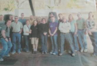 A mission team of about twenty people posing together outdoors